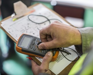 Electrician holding mobile device