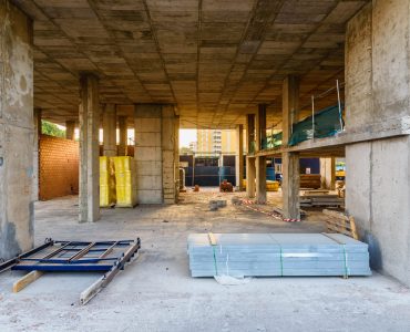 Valencia, Spain - July 3, 2019: Interior of a building under construction, with its cement walls and foundations in sight.