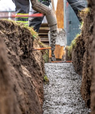 pour concrete from the mixer of the foundation of the building in the ground.